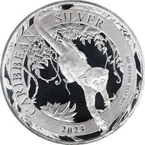 2023 - A green monkey hanging from a tree by its tail