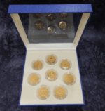 A set of 8 commemorative coins, 8 days of birth, made of cupronickel, gold plated, packed in a leather box with a certificate from the Treasury Department.